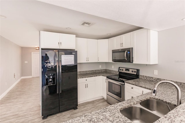 kitchen featuring black appliances, white cabinetry, and sink