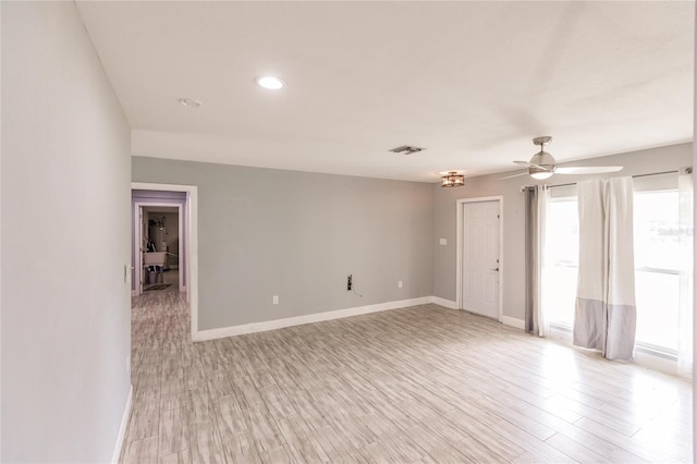 spare room featuring ceiling fan and light hardwood / wood-style flooring