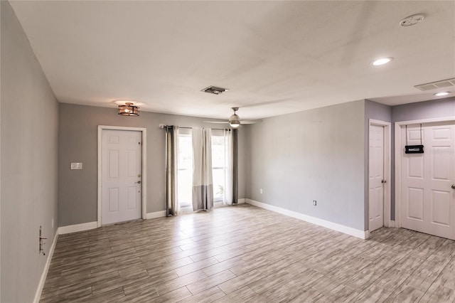 foyer with ceiling fan and light wood-type flooring