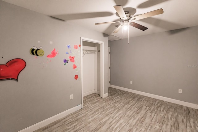 unfurnished bedroom featuring light hardwood / wood-style floors, ceiling fan, and a closet