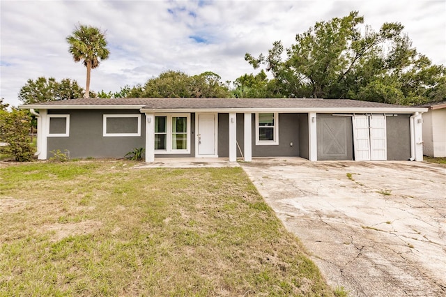 single story home featuring a garage and a front lawn