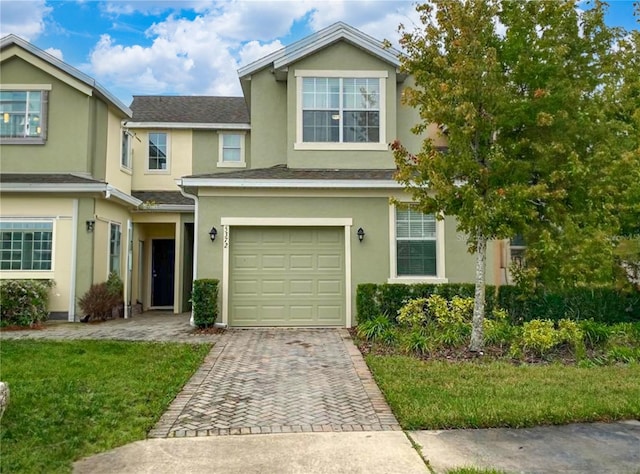 view of front of property with a garage and a front yard