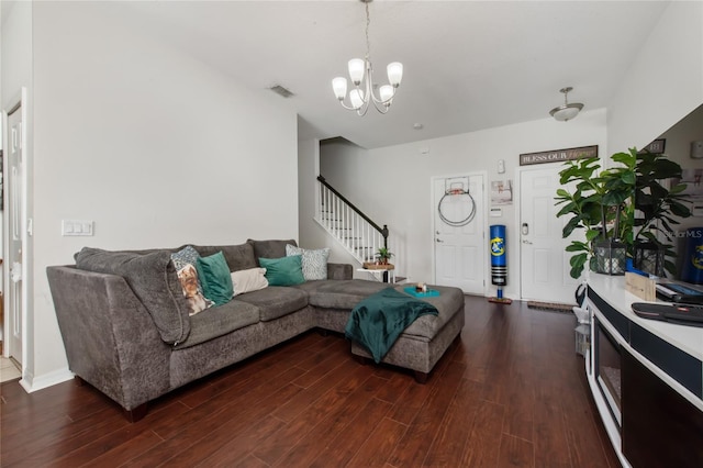 living room with a chandelier and dark hardwood / wood-style floors