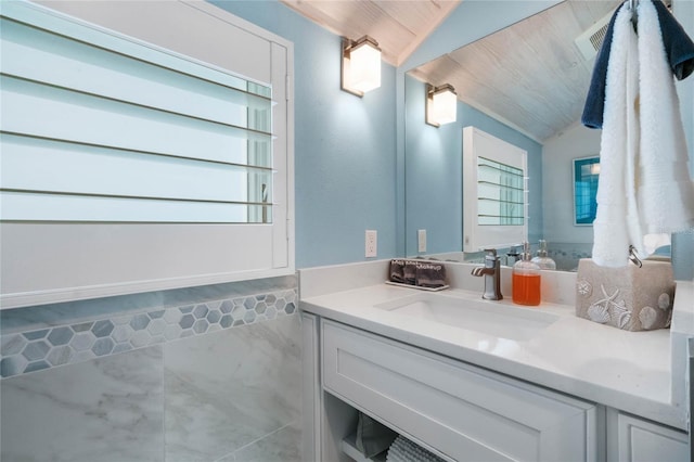 bathroom featuring vaulted ceiling, wood ceiling, and vanity