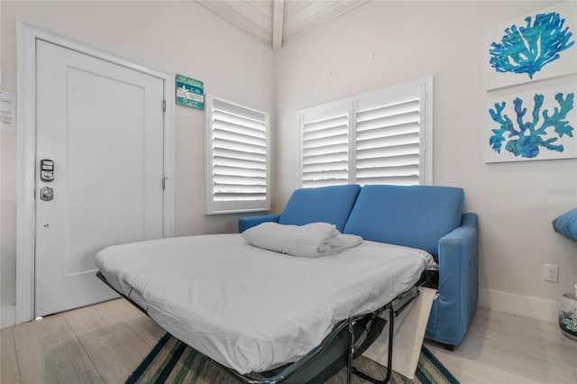 bedroom featuring baseboards, a closet, and light wood-style floors