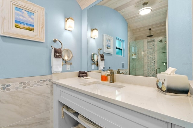 bathroom with a shower with door, vanity, and wooden ceiling