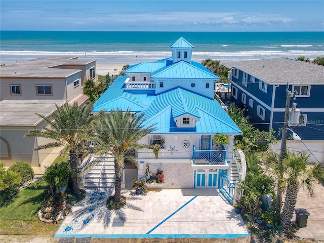 bird's eye view with a water view and a beach view