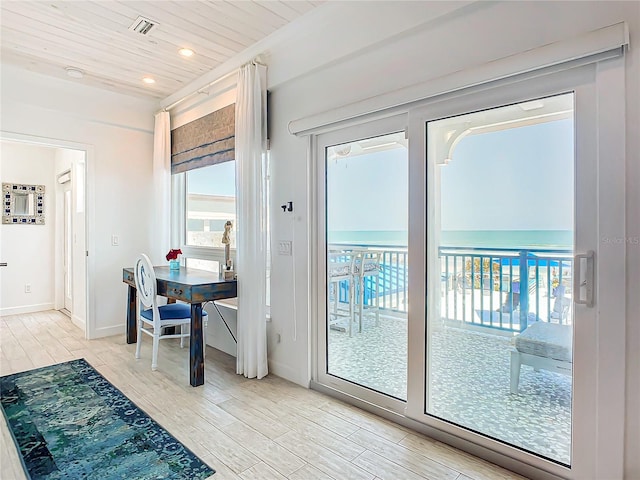 entryway with visible vents, a wealth of natural light, wood finished floors, and wood ceiling