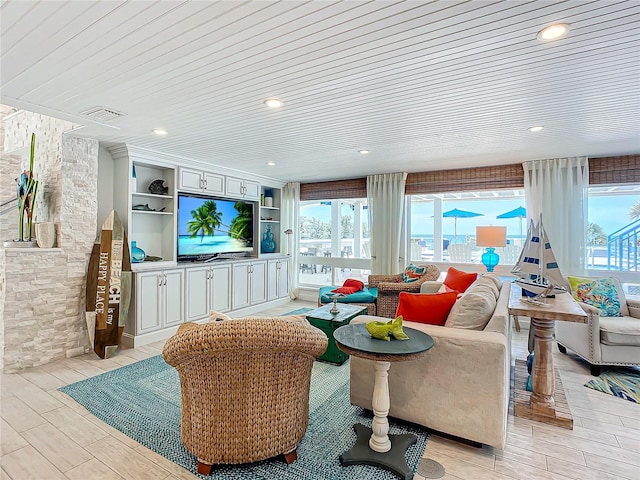 living area with wood finish floors, built in features, and recessed lighting