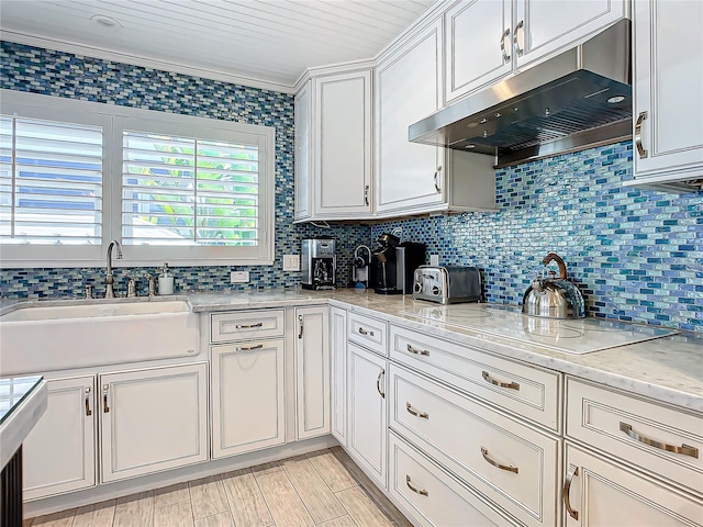 kitchen with white cabinetry, tasteful backsplash, electric cooktop, sink, and wood ceiling