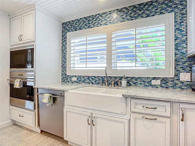 kitchen featuring light hardwood / wood-style flooring, stainless steel appliances, sink, ornamental molding, and light stone counters