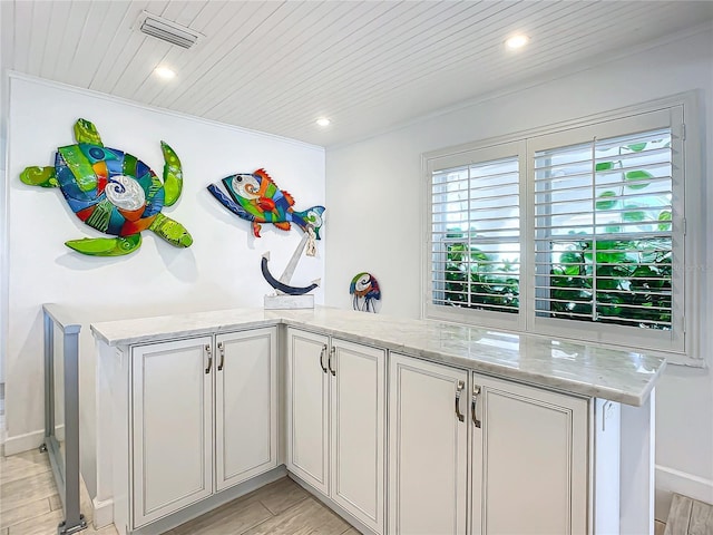 kitchen featuring wood ceiling, light stone countertops, visible vents, and light wood-type flooring