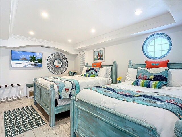 bedroom with wood tiled floor and recessed lighting