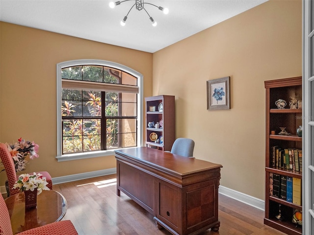 office with an inviting chandelier, baseboards, and dark wood-style floors