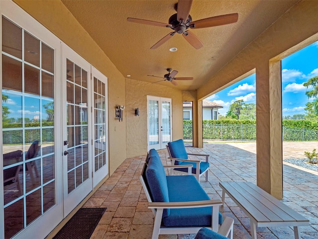view of patio with french doors, fence, and a ceiling fan