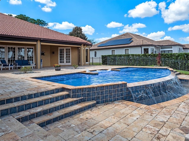 view of pool with fence, a jacuzzi, a fenced in pool, a patio area, and french doors
