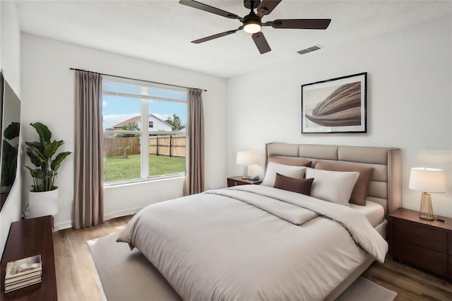 bedroom with ceiling fan and wood-type flooring