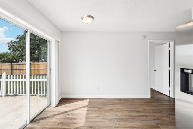 interior space featuring a textured ceiling and hardwood / wood-style floors