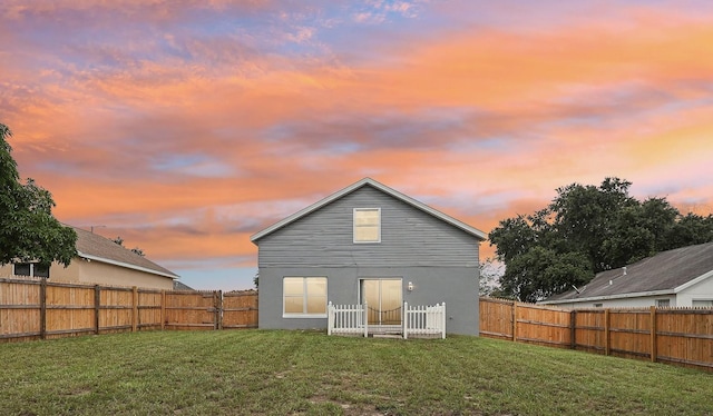 back house at dusk with a yard