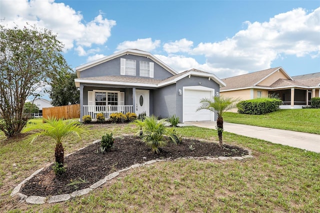 view of front of home featuring a garage, a front yard, and a porch