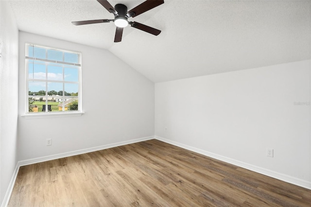 bonus room with ceiling fan, light hardwood / wood-style floors, a textured ceiling, and vaulted ceiling