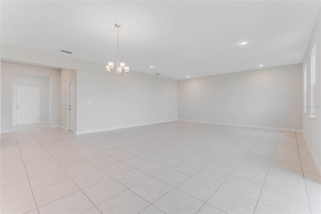 empty room featuring light tile patterned floors, visible vents, baseboards, an inviting chandelier, and recessed lighting