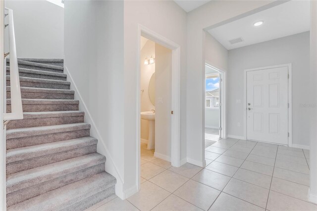 stairway featuring tile patterned floors