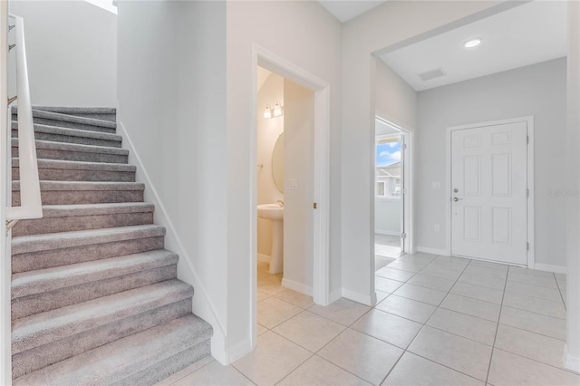 staircase featuring tile patterned floors, visible vents, recessed lighting, and baseboards