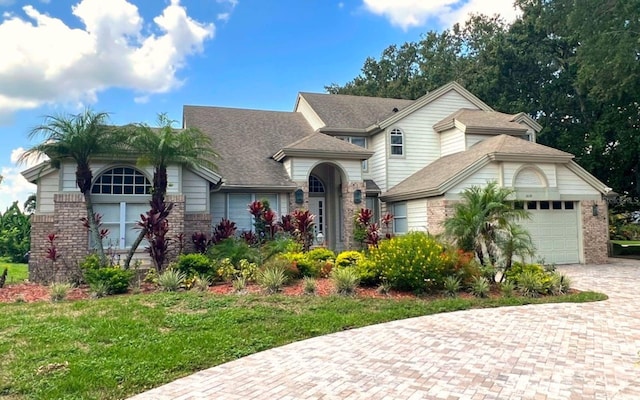 view of front of home featuring a garage and a front lawn