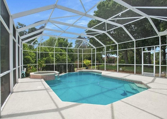 view of pool with glass enclosure, an in ground hot tub, and a patio area