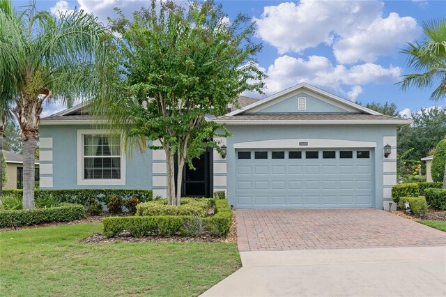 view of front of house featuring a front lawn and a garage