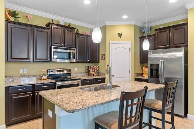 kitchen with hanging light fixtures, stainless steel appliances, sink, and dark brown cabinetry