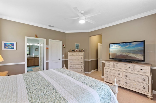 bedroom with ceiling fan, light colored carpet, crown molding, and ensuite bath