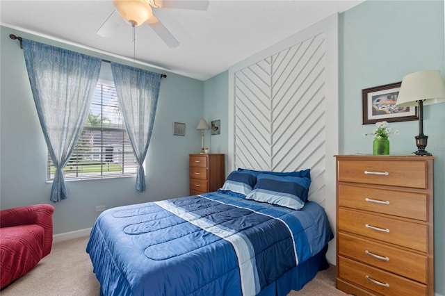 bedroom with ceiling fan and light carpet