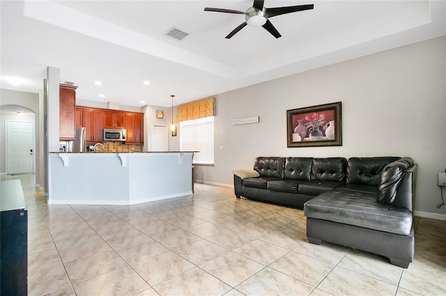 tiled living room with ceiling fan