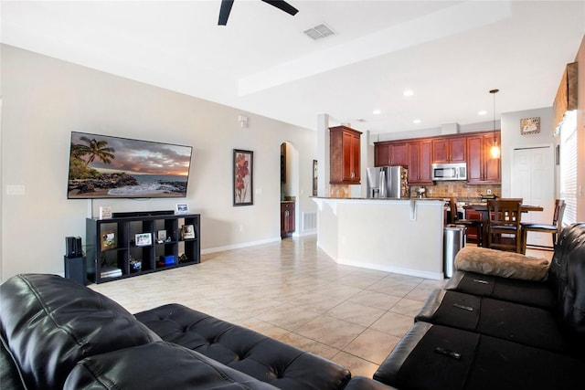 tiled living room with ceiling fan