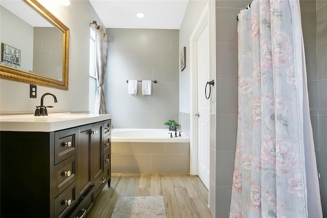 bathroom with vanity, hardwood / wood-style flooring, and shower / bath combination with curtain