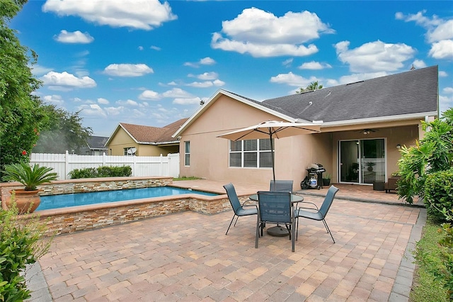 exterior space with a fenced in pool and a patio