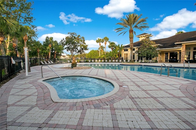 view of swimming pool with a patio and a hot tub