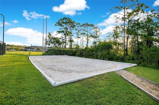 view of property's community featuring a lawn and volleyball court