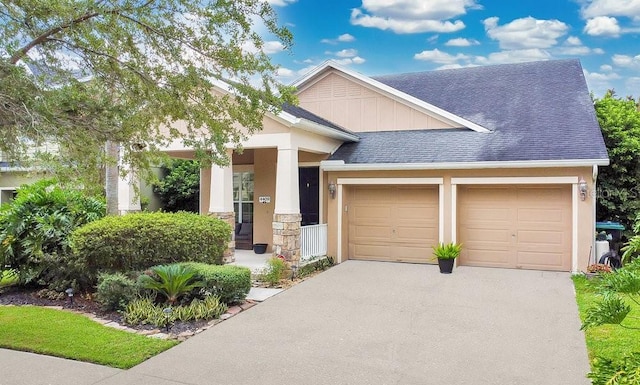 craftsman inspired home with aphalt driveway, an attached garage, a shingled roof, stucco siding, and board and batten siding