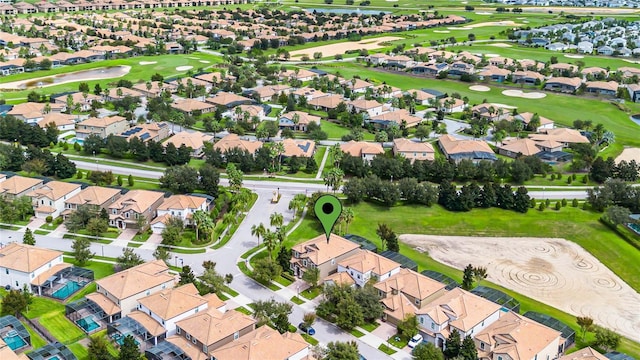 aerial view featuring view of golf course and a residential view