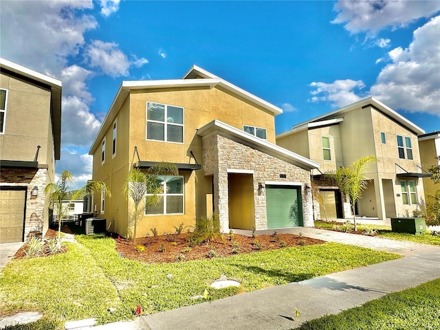 9095 Sommerset Hills Dr, Davenport, FL 33896 - view of front facade featuring stucco siding, stone siding, driveway, a front lawn, and central AC