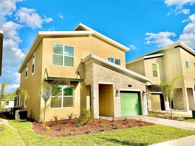 view of front facade with a garage and cooling unit