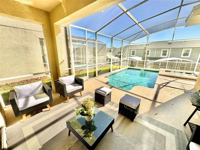 view of pool featuring a lanai, a patio area, and an outdoor hangout area