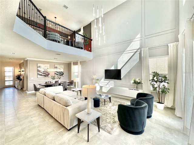 9095 Sommerset Hills Dr, Davenport, FL 33896 - living area with visible vents, a high ceiling, and a decorative wall