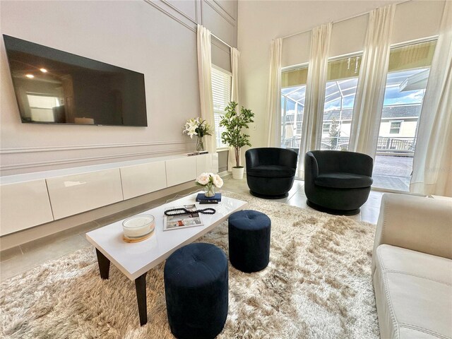 tiled living room featuring a healthy amount of sunlight