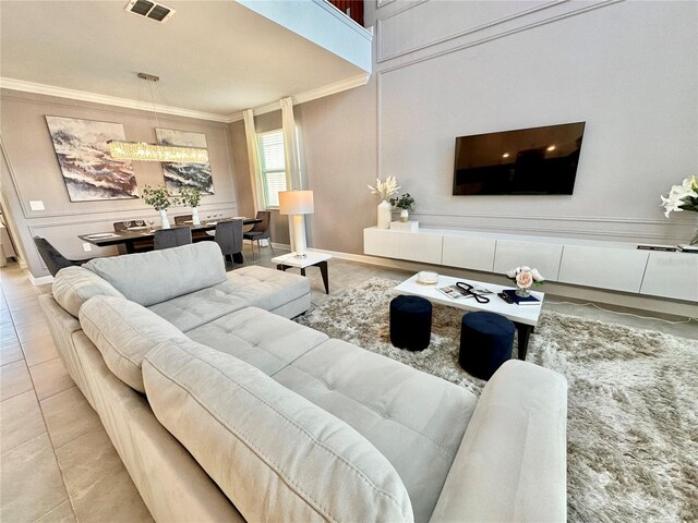 living room featuring crown molding and light tile patterned floors