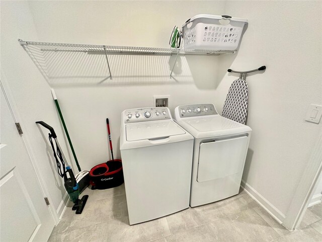 clothes washing area featuring washing machine and clothes dryer