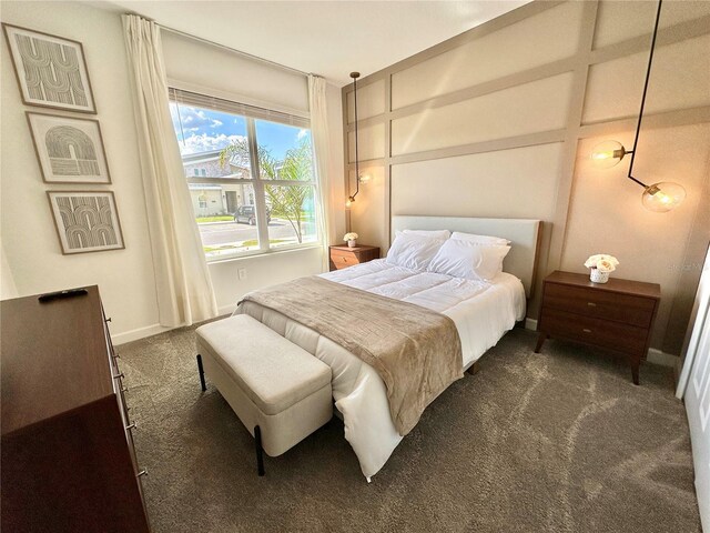 9095 Sommerset Hills Dr, Davenport, FL 33896 - bedroom with baseboards, a decorative wall, and carpet flooring